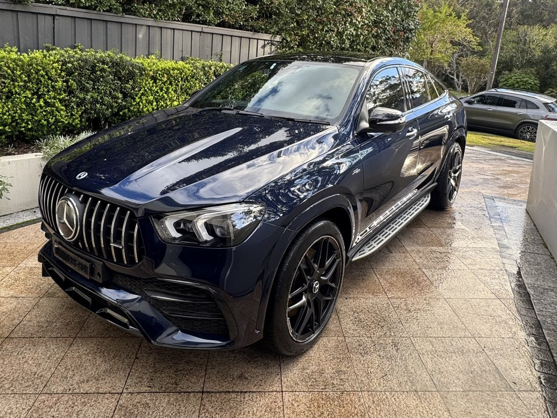 Dark blue Mercedes-AMG GLE Coupé gleaming on a driveway after a STIKKYS detail