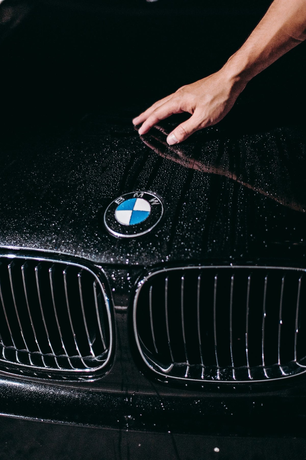 Water beading on a glossy black BMW bonnet
